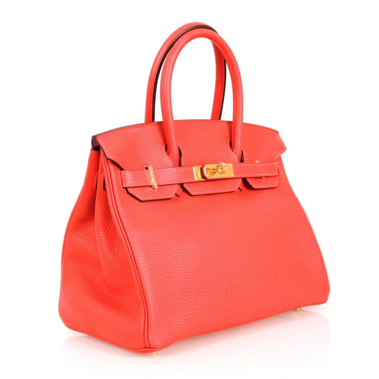 This is an authentic Hermes Togo Leather Classic Birkin 30 in Rogue Pivione. This Birkin clemence leather in rouge pivione with trim found at the piping, side gussets, top handles and straps. The bag features rolled top handles, a strap closure with