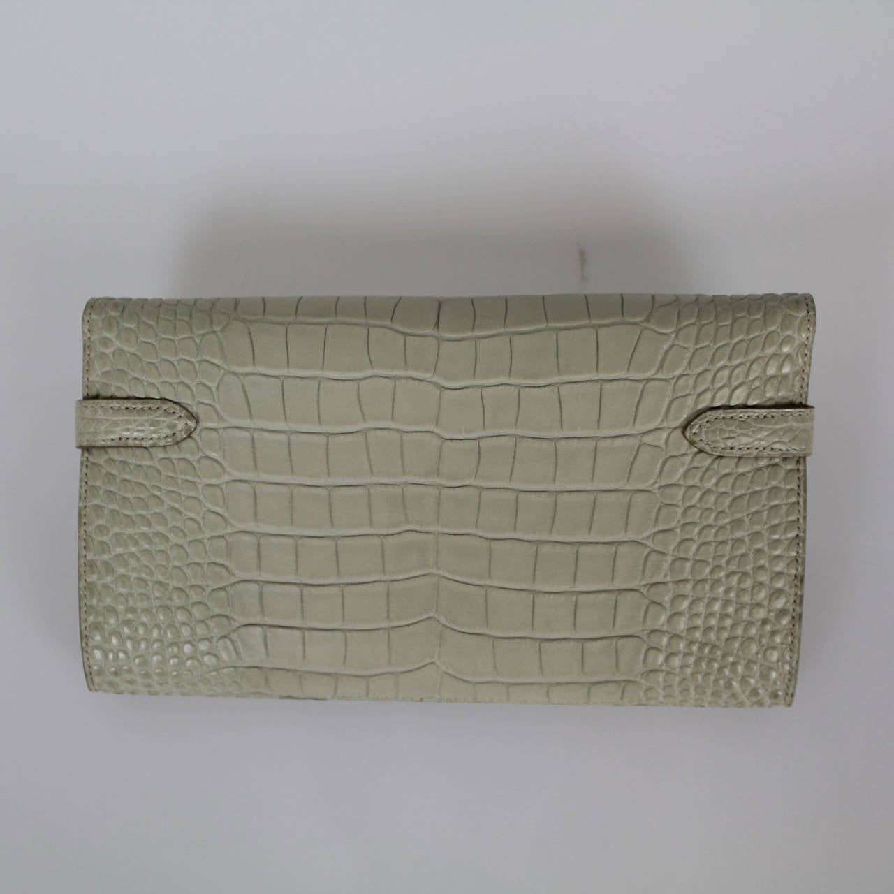 Hermes crocodile made wallet, which is extremely delicate and rare, with an enviable quality and finesse. 

Includes:
-Hermes Box 

Specifics:
-Blue Matte Crocodile 
-Palladium Hardware 
-(12) Credit Card Slots
-(2) Interior
