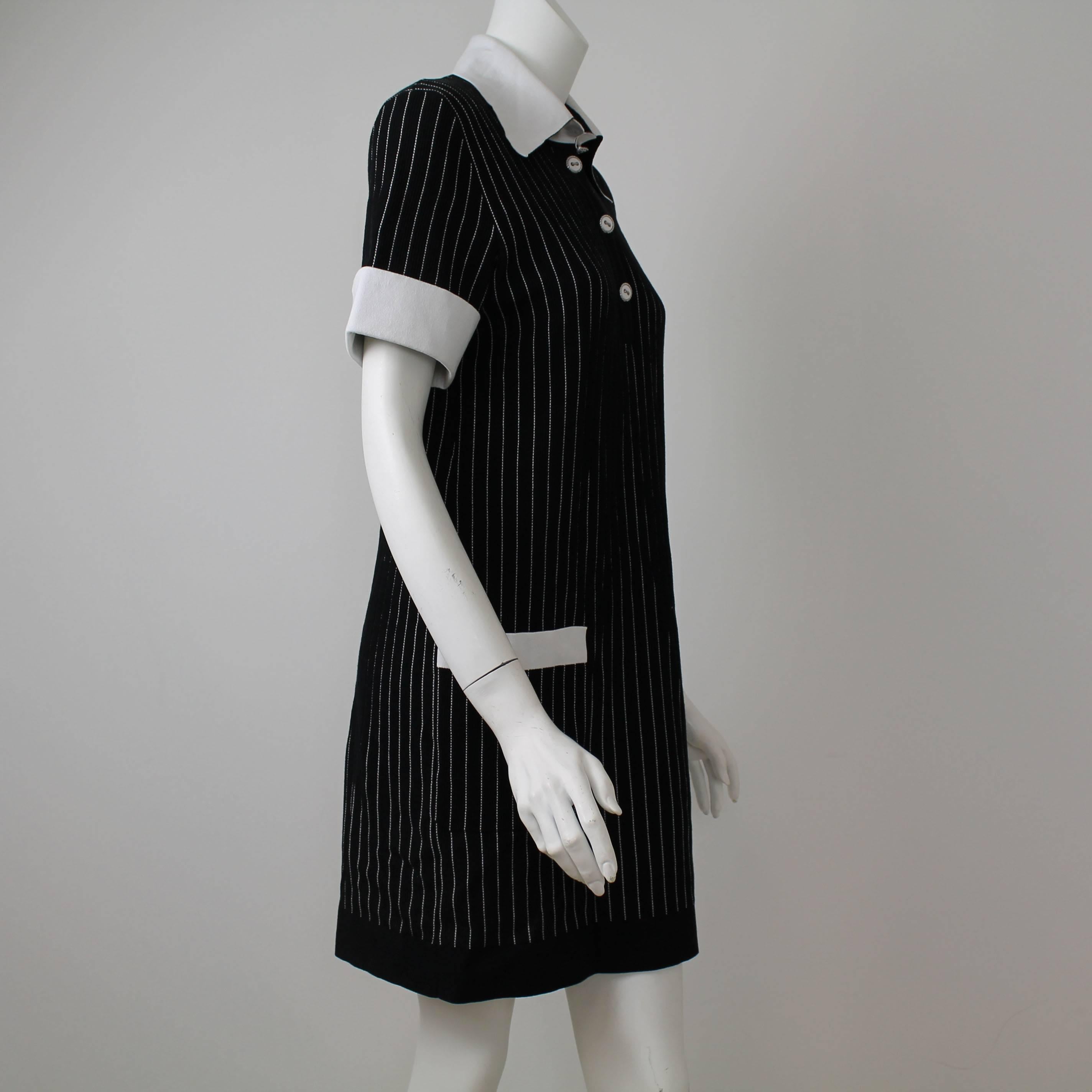 Chanel black and white pinstripe shirt dress perfect for the summer. Features: White collar, pinstripe, 84% cotton, 16 % nylon. 3/4 sleeve, above the knee. 

Conditions: Brand New

Does not include anything