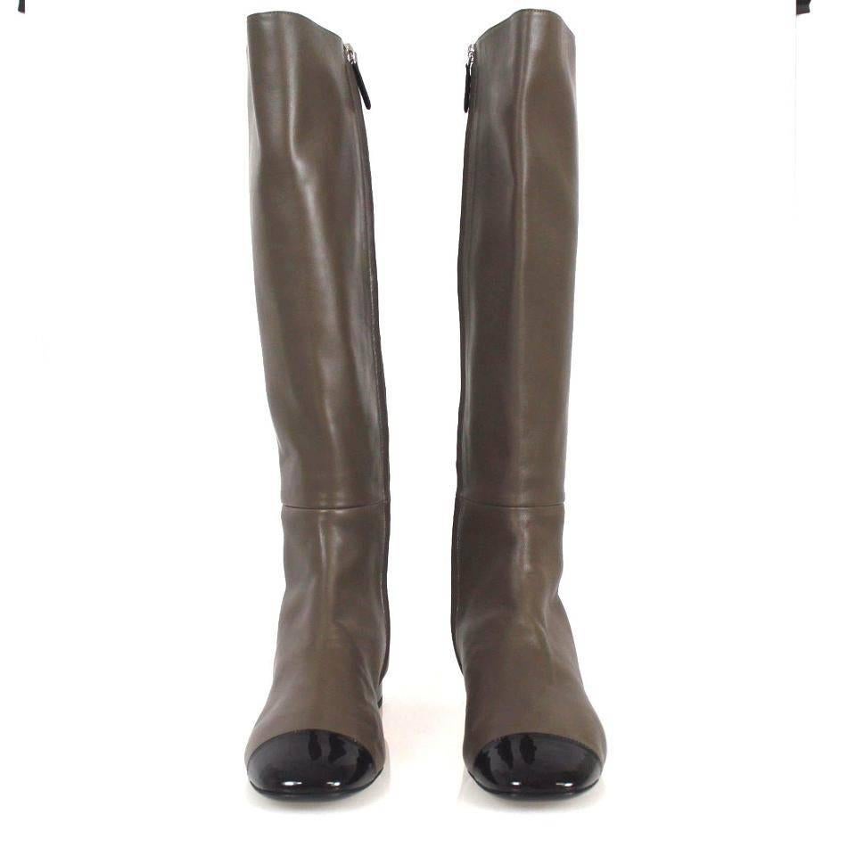 Chanel 2015 riding equestrian style boots, perfect for this fall and winter! Dark Brown taupe leather with patent leather black cap toes, lined with tan leather.

 38.5 EU.

Includes: Dust bag

DOES NOT INCLUDE TAGS AND BOX 

About us:
We