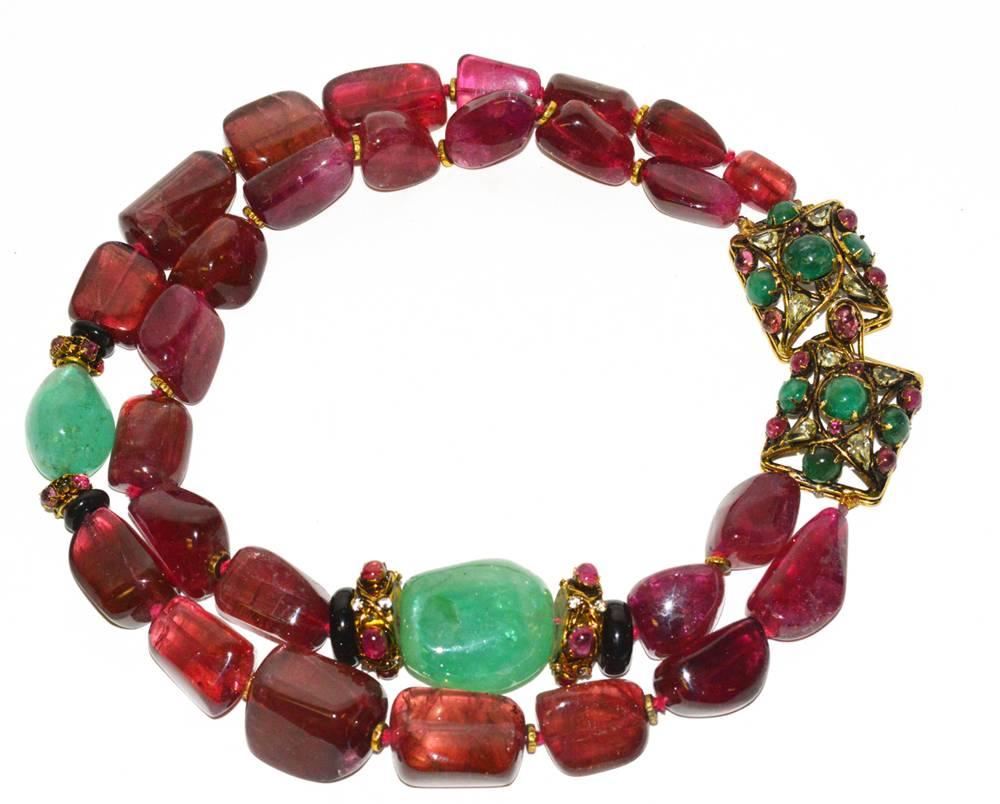 This is a most magnificent suite by Iradj Moini. Genuine tumbled, large, pink/red natural, un-dyed, rubellite tourmaline and emeralds. One of his most gorgeous pieces.this is one of a kind and in pristine condition. Comes with coordinating clip on