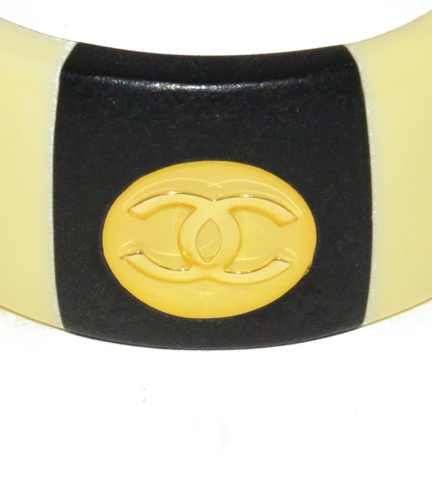 Chanel wide resin black and buttery gold Chanel bangle with logo inserts, in pristine condition.  Fits M-L wrist.