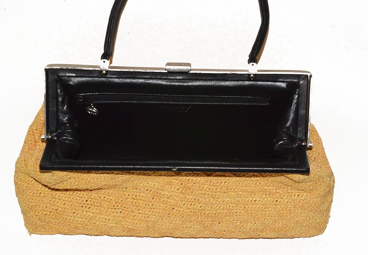 Gorgeous, classic Chanel natural straw and black lambskin top handle bag in pristine condition. Inside zippered compartment. 