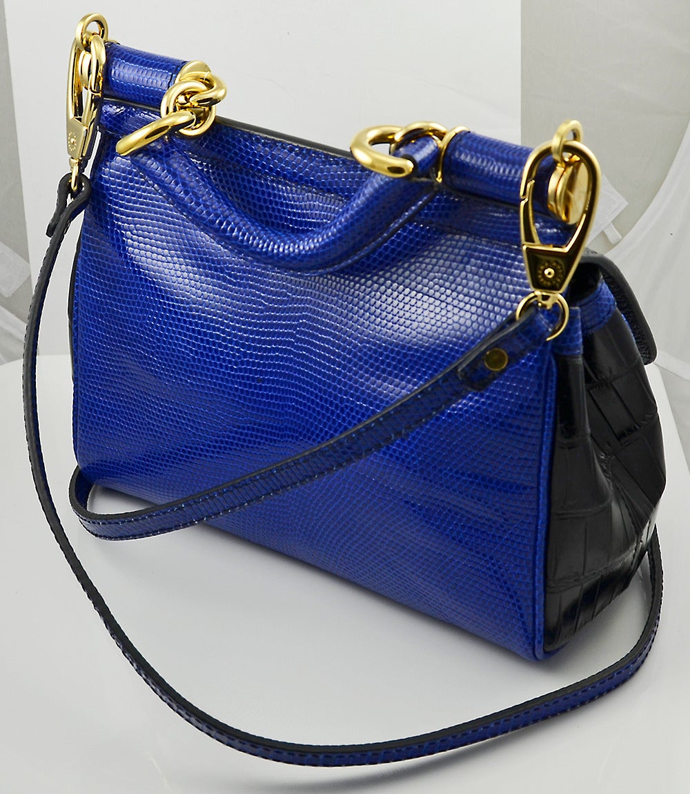 Striking royal blue lizard and black crocodile Dolce and Gabbana handbag. Top handle and shoulder strap. 

All proceeds from the POSH Sale benefit Lighthouse Guild, the world-wide leader in helping people who are blind or visually impaired as well