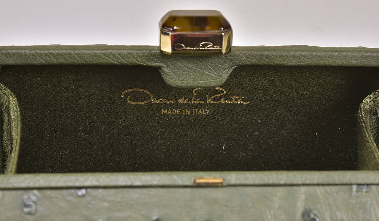 Truly a classic, this is a gorgeous Oscar de la Renta ostrich clutch in olive green. It is in pristine condition and a great pop of color for everything in your wardrobe.