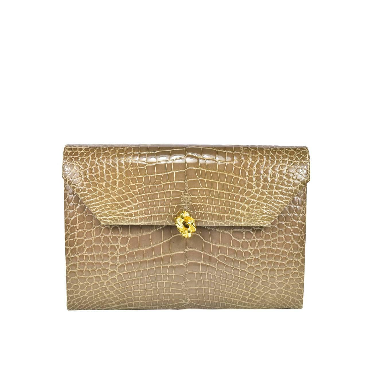 This classic Helene Arpels taupe alligator beauty can be worn in your choice of 3 ways. As a clutch, or with a gold shoulder chain or alligator strap. Day to night, this is a fabulous bag in pristine condition.