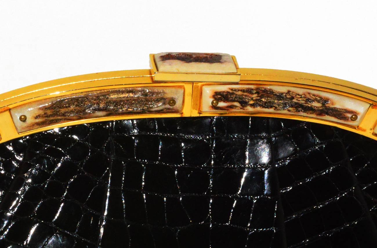 Rare Judith Leiber genuine Alligator and Bone Clutch. 

Mirror, change purse and comb in pristine condition.