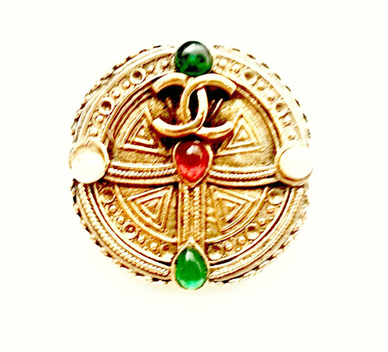 A rare Chanel couture 1989 Byzantine Gold Brooch with Emerald and Ruby cabochons and Pearls. 

The brooch, which is gold-plated, not gilt, has an intricate Maltese Cross pattern.The gold is distressed  to create the impression of antiquity and has