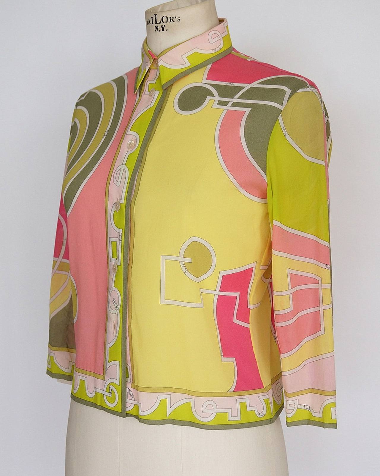 A very pretty and rare late 1960s or early 70s Emilio Pucci silk blouse in a size Small to Medium. The pink, yellow and pale green print is fresh and unusual and not one I have seen before. (I did find a picture of Barbara Eden in a fairly similar