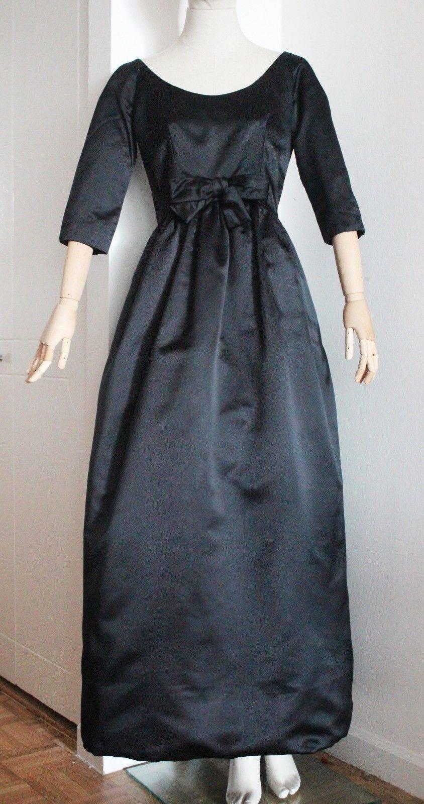 A rare and iconic 1958 Yves Saint-Laurent for Christian evening dress in black satin from the Automne-Hiver collection,.

Yves Saint-Laurent was barely 21 when he took over as head of design at Christian Dior,after Monsieur Dior's sudden death in