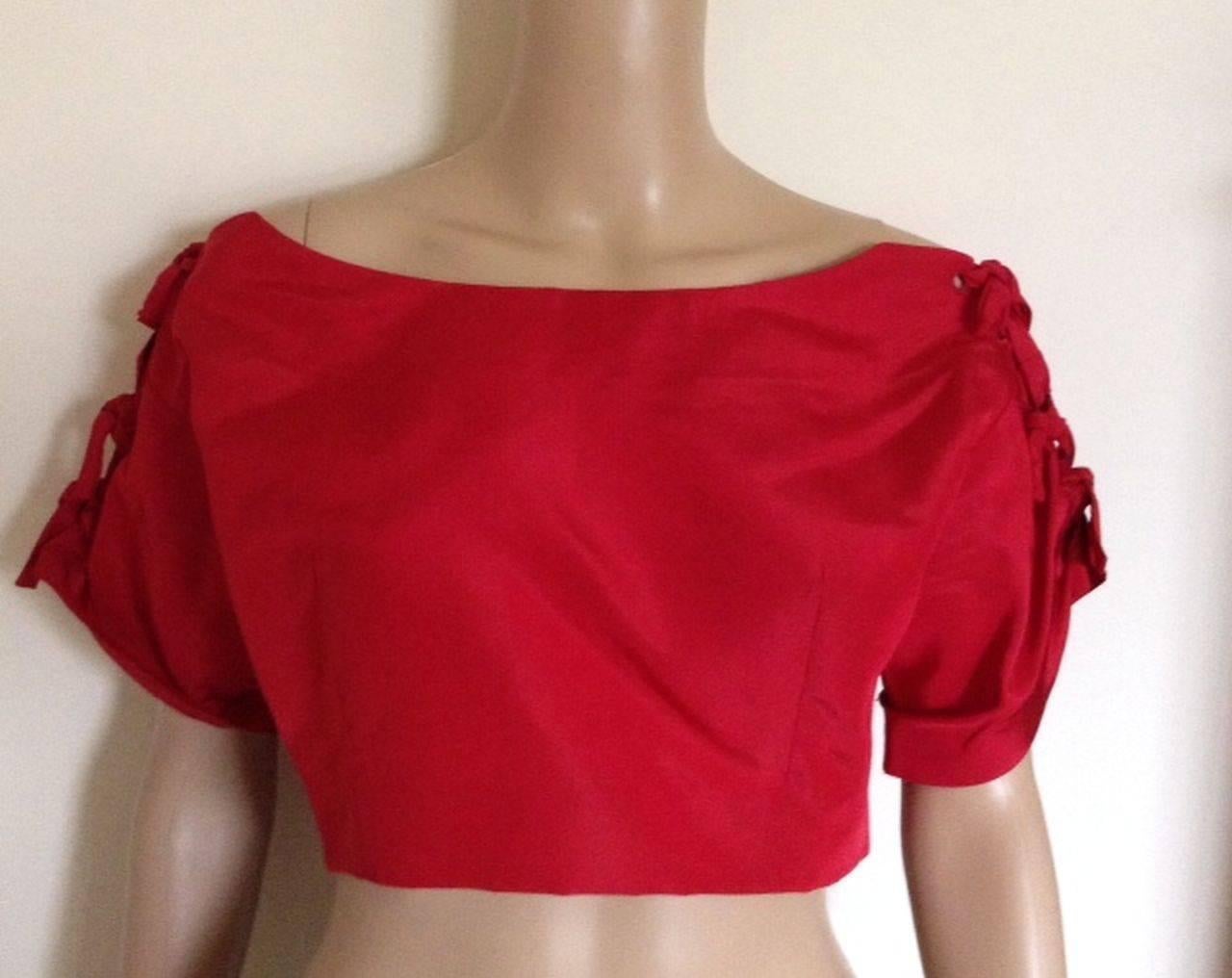 Rare 1953 Christian Dior red silk bolero jacket from the House of Dior's legendary 'Tulip' collection.

A perfect way to introduce vintage into your wardrobe, this wonderful jacket exemplifies the couture design values of Dior while being sharp