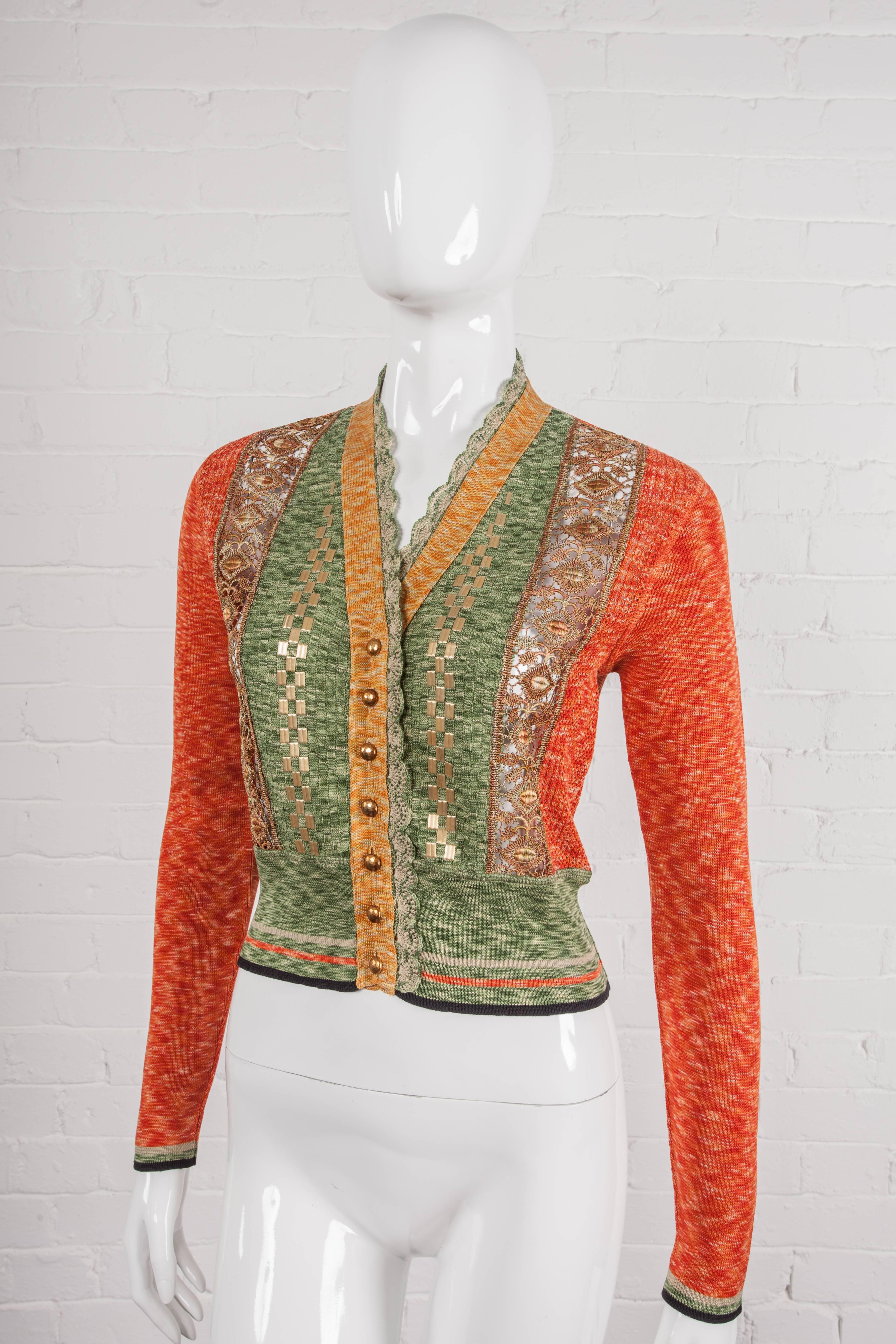 Panelled all-cotton waist-length cardigan, featuring lace panelled front and metal buttons. From the Spring/Summer 1989 “Around the World in 168 Outfits” Collection featuring a metal pattern incorporated into the central front panels.

Period: