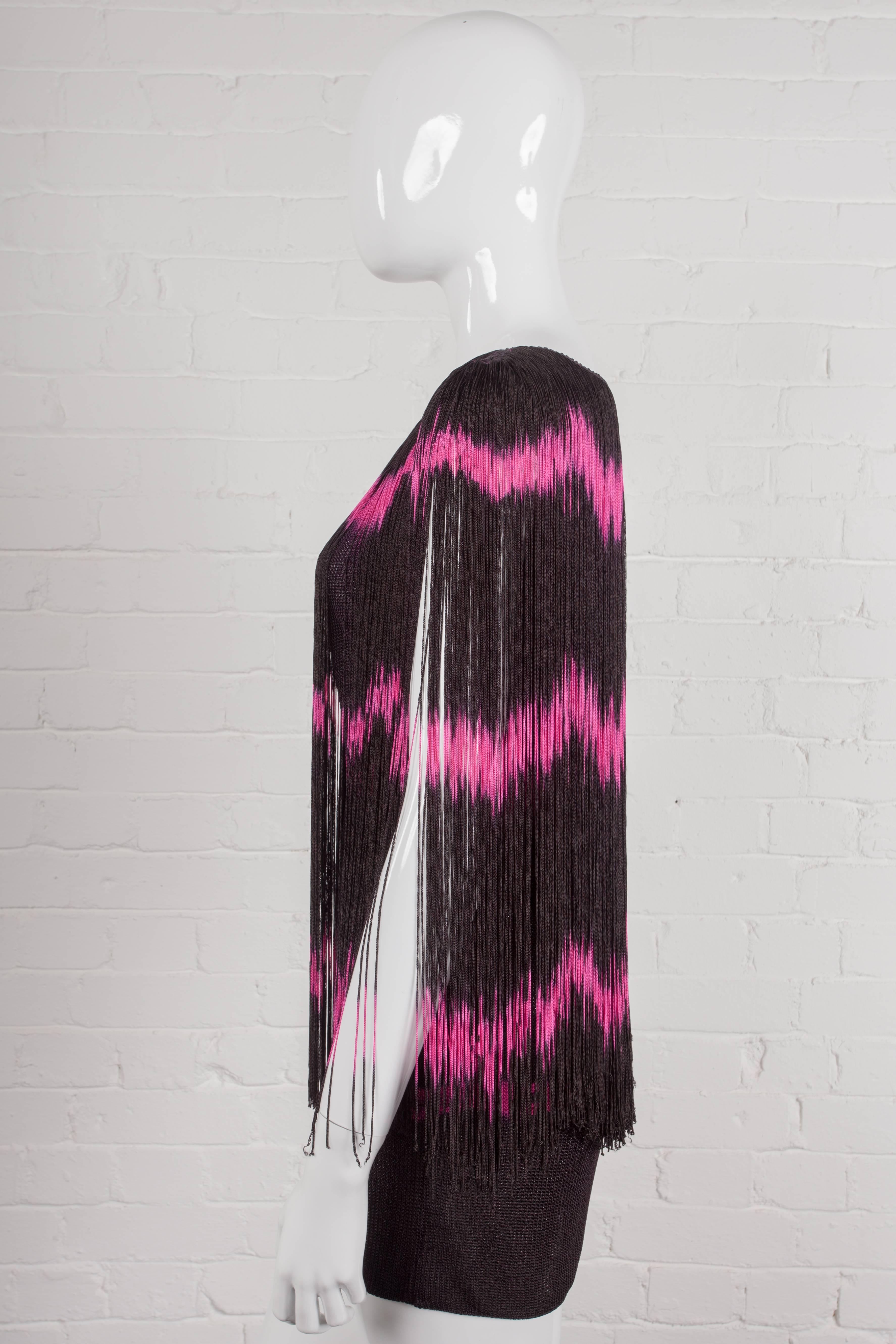 Fringed sleeveless tunic with a black and pink tie-dye effect design front and back. Made in a stretch viscose rayon material. From the Spring/Summer 1985 “A Wardrobe for Two” Collection.

Period: 1980s – Spring/Summer 1985

Origin: