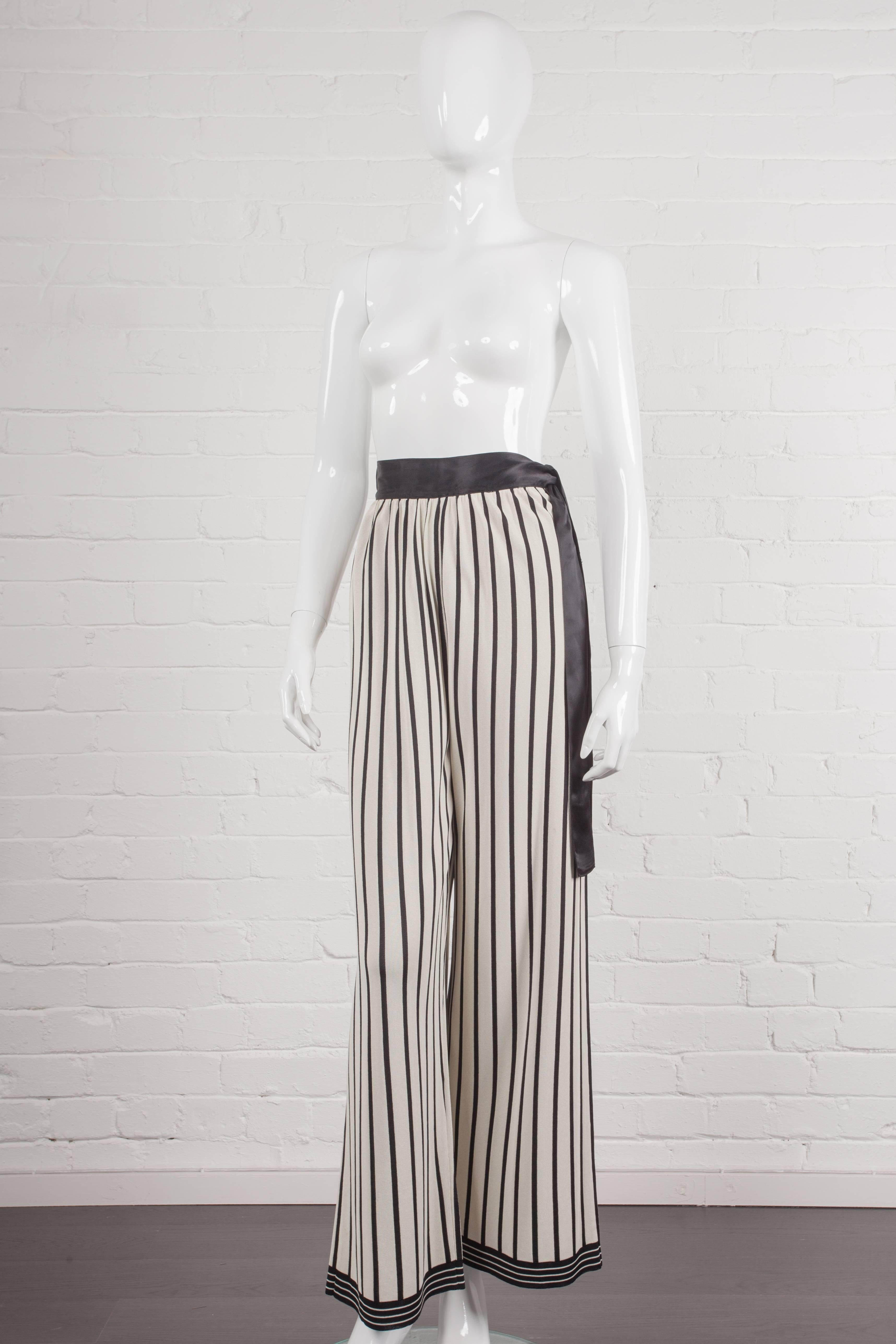 Full-length cream and black striped trousers with wide leg and gathered at the waist, made from heavy viscose rayon with minimum stretch. From the Spring/Summer 1988 “The Concerge In the Staircase” Collection. Features a ‘Mother of Pearl’ button