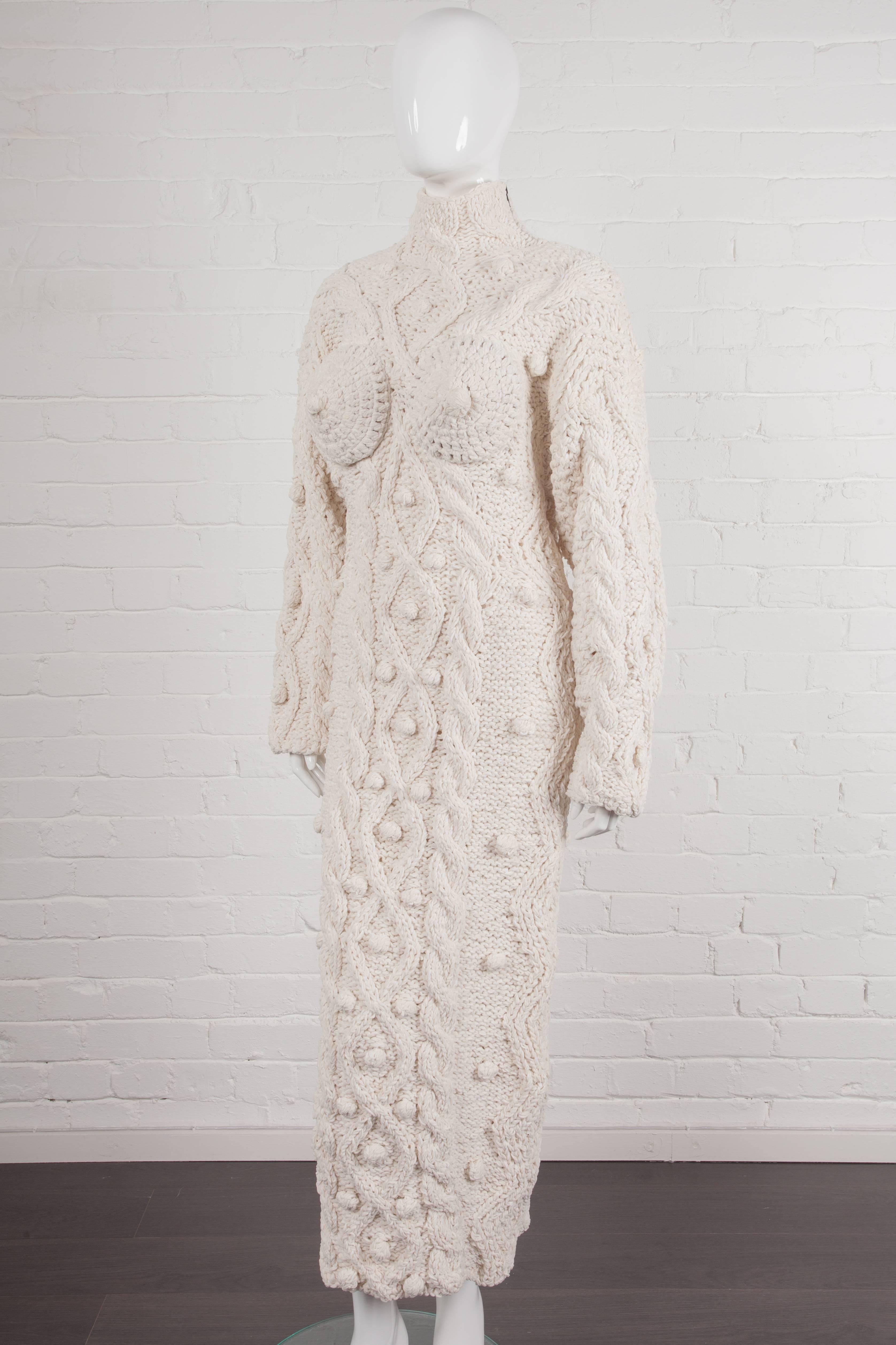 Vintage Aran Knit Cones Dress.

Off white cotton chenille yarn Aran knit long breast cones dress from Jean Paul Gaultier  Fall/Winter 1985/86 “The Uptide Charme of the Bourgeoisie” Collection featuring a high crew neck, a metal zip opening at the