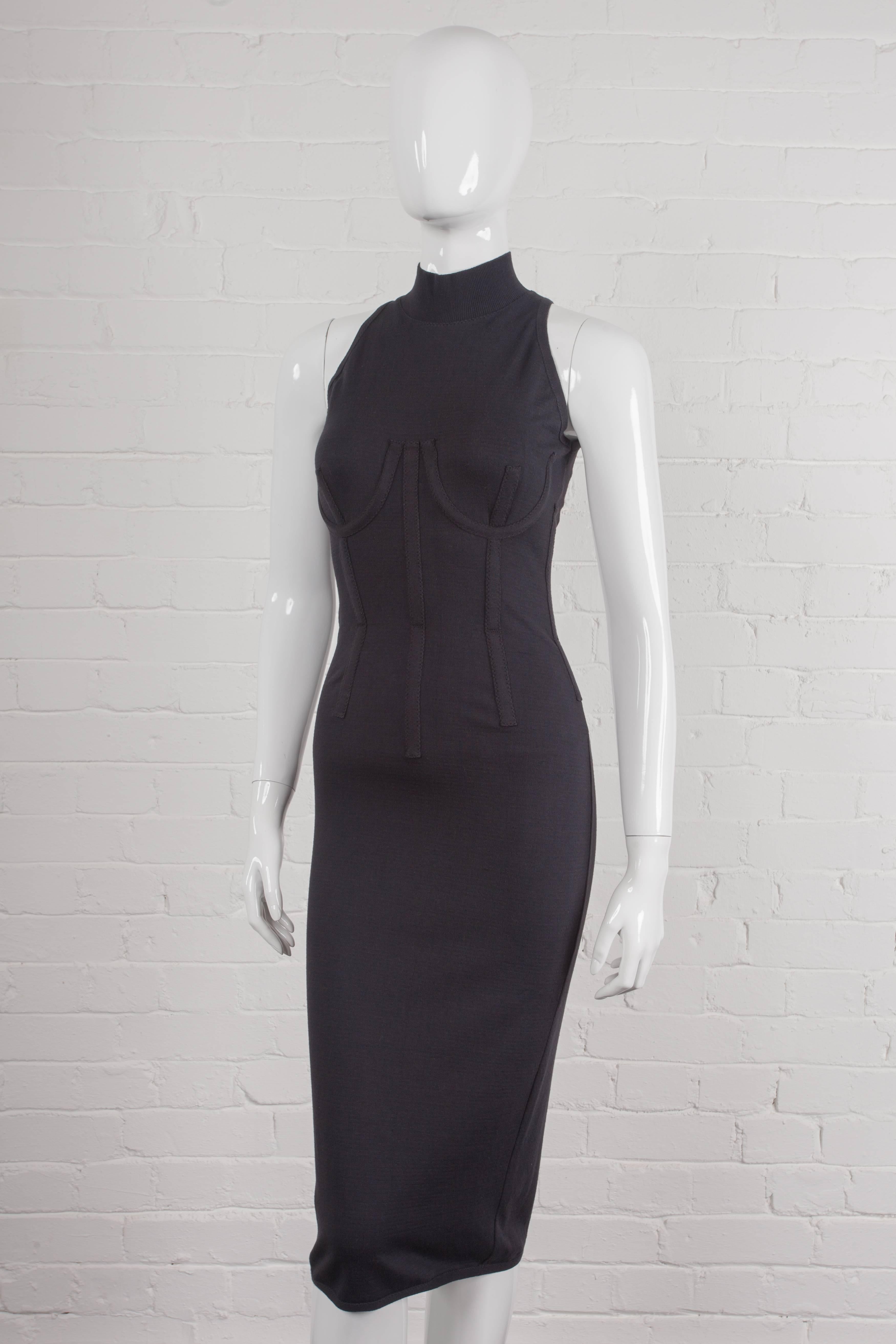Vintage 1993 corset bodycon dress.

Black calf-length fitted dress with a stretch crew neck made from cotton blended with polyamide. From the Spring/Summer 1993 “Gaultier Classic Revisited” Collection. Features under-wiring on the outside to the
