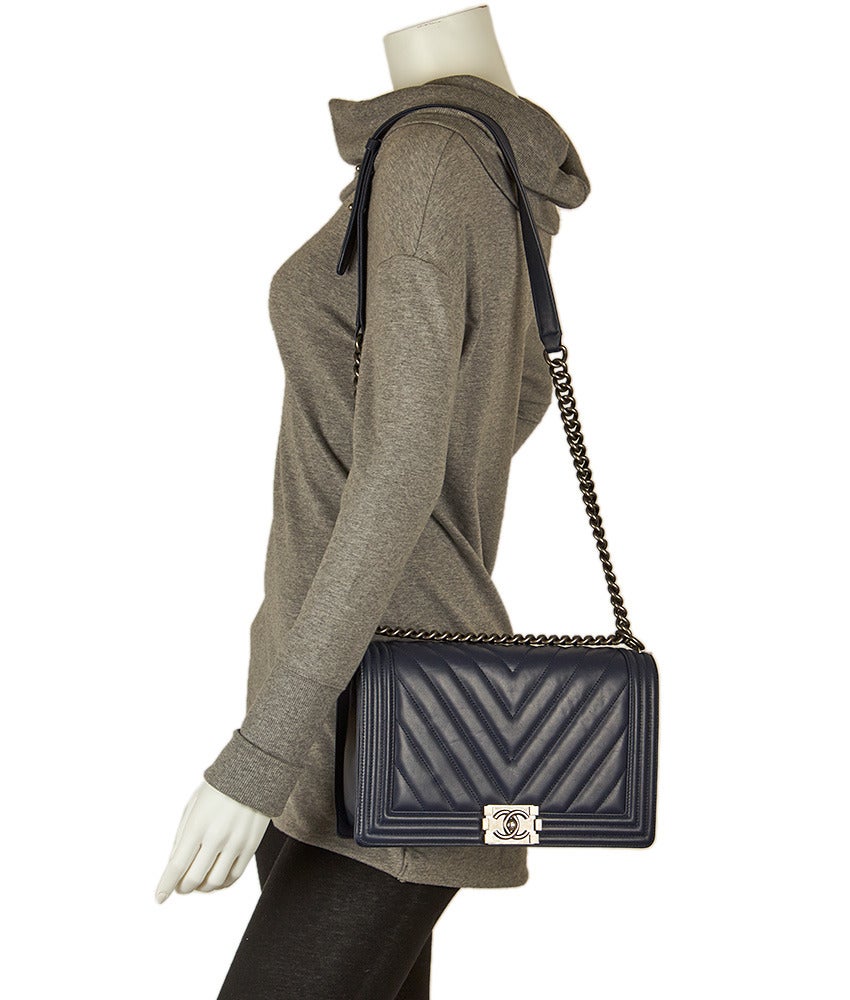 This chic Chanel chevron Le Boy bag features a flap and lock closure, with a chain and leather shoulder strap.
Named after Boy Capel (who financed Coco Chanel's first shops) the Le Boy line of bags was introduced by Karl Lagerfeld in 2013,