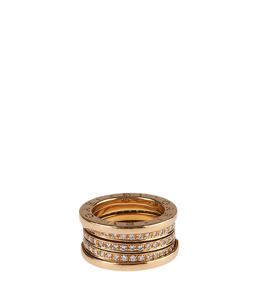This gorgeous Bvgari Zero1 ring features three separate interior gold bands set with 1 point diamonds. The diameter of the ring is 11mm, and the width of the band is 10mm.