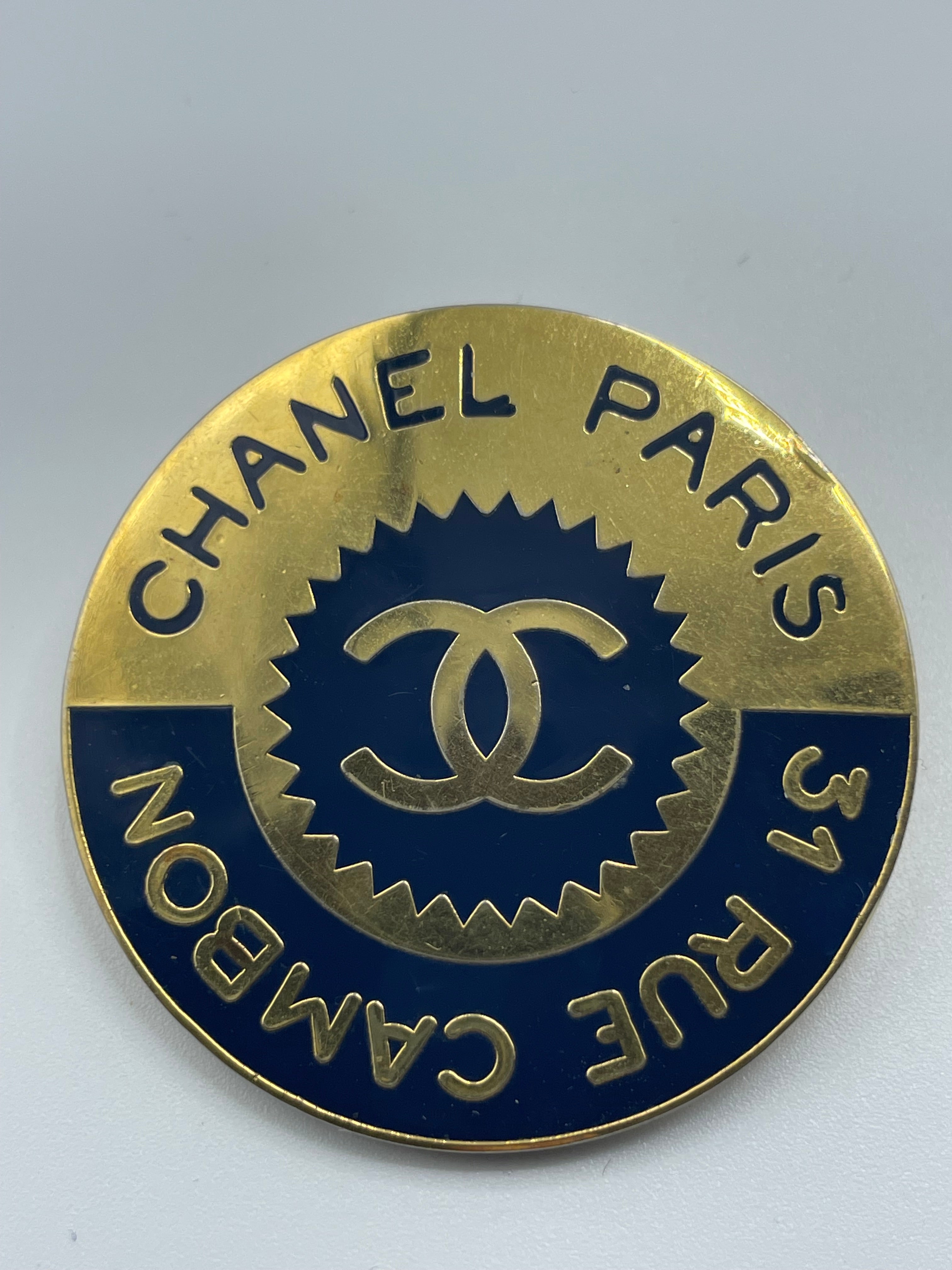 Chanel 31 Rue Cambon Paris Brooch.  A black and gold circular brooch with the Chanel CC in the center. 
Chanel stamp in the reverse.
Made in France. 
In perfect condition and quality. 