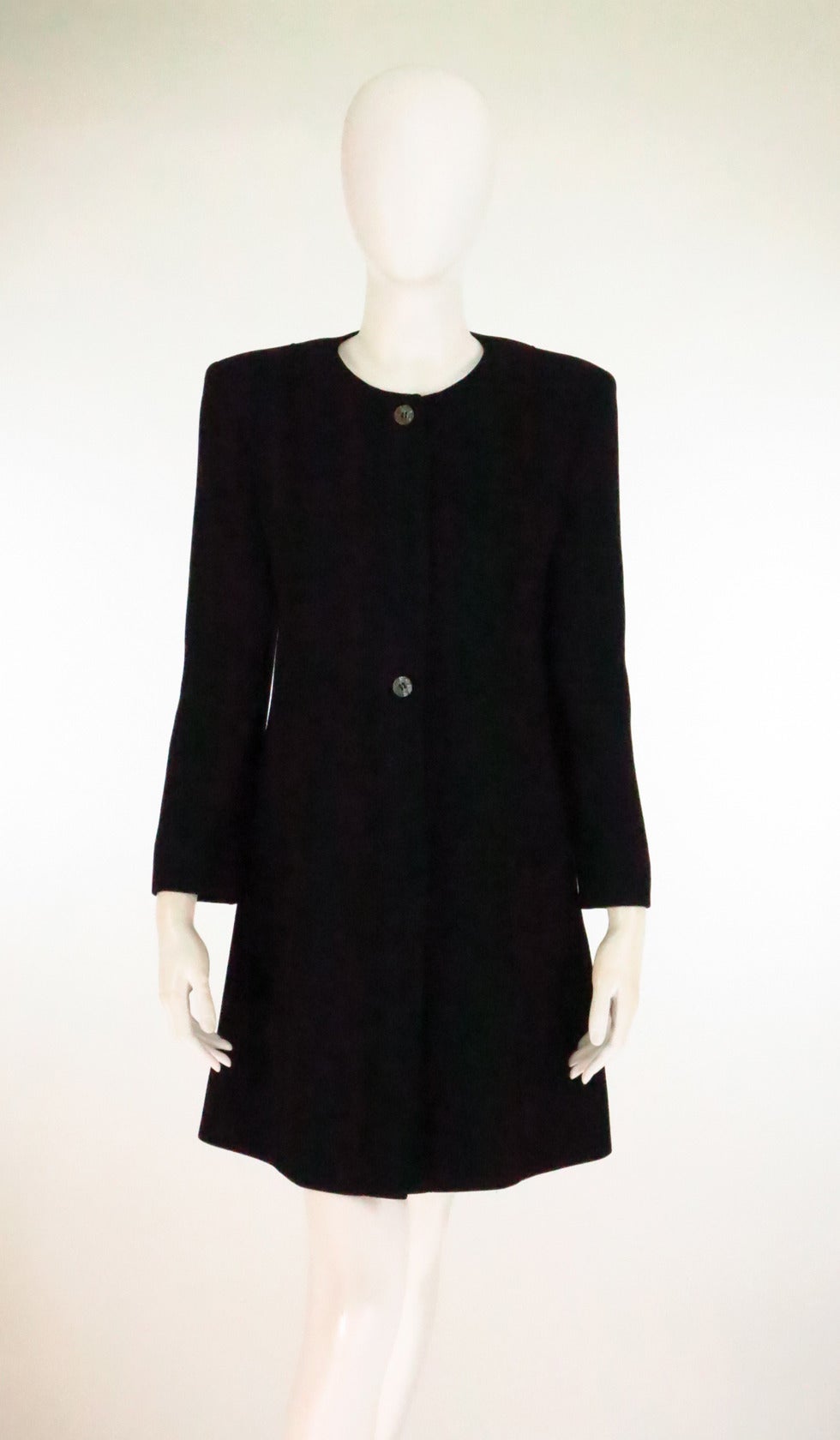 Fendi Black wool reversed seam collarless coat...Simple style, this coat looks great with trousers, jeans or skirts...Fitted A line coat has a jewel neckline, hidden dark mother of pearl button, placket front coat, with decorative reverse seaming at