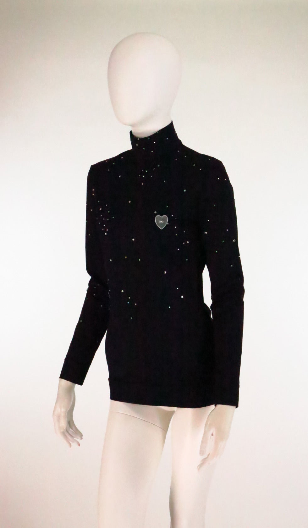 Moschino Star Gazer embroidered rhinestone black silky (nylon/spandex) pull on top...Mock turtle neck with back zipper...Long sleeves...The top front, neck and sleeves are sprinkled with clear rhinestones in small and medium sizes...Over the left