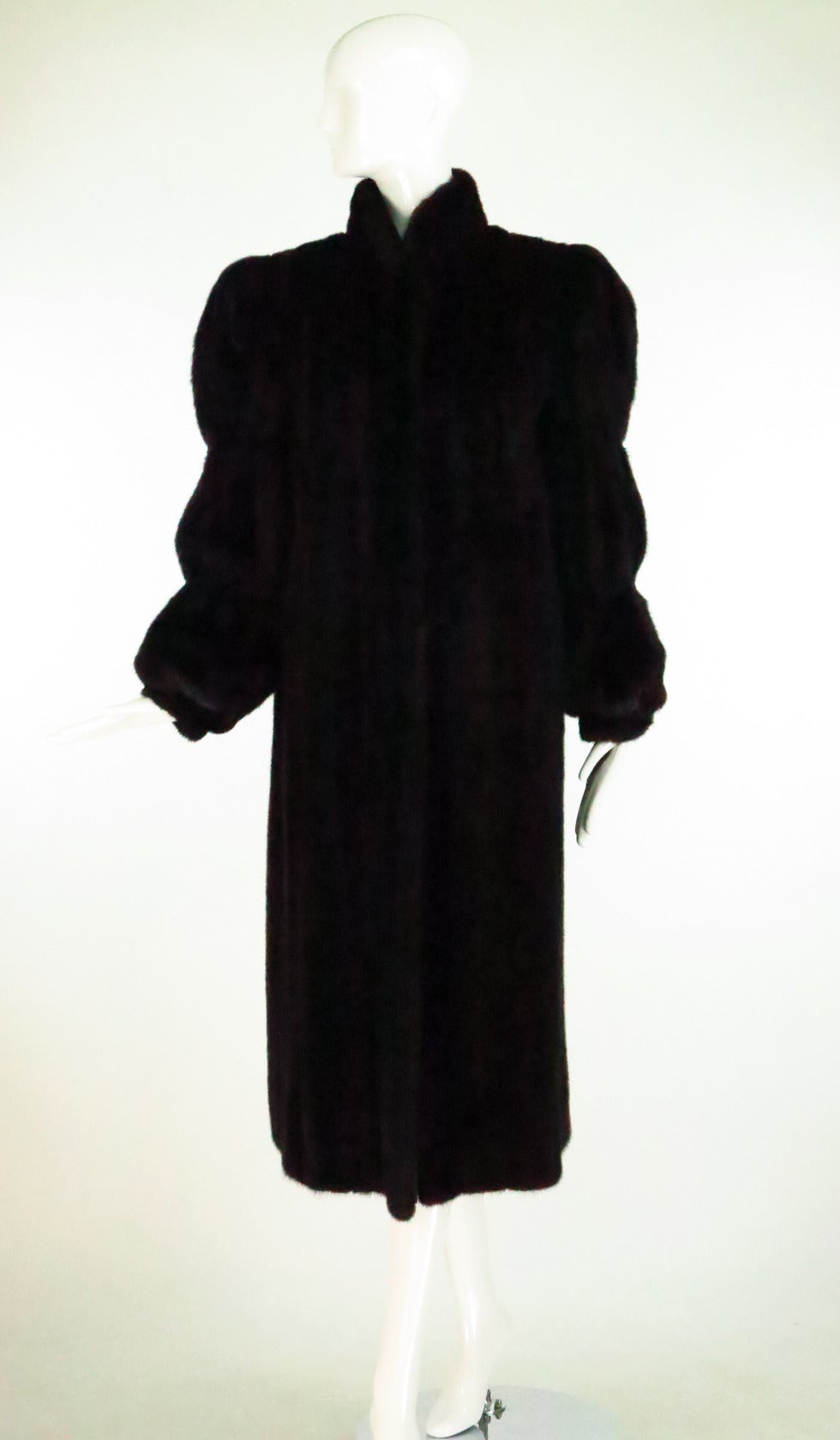 Gorgeous Blackglama female mink fur coat from Antonovich...Luxurious dark mink that glistens! 1970s...High banded collar...The sleeves are banded above and below the elbows and have deep banded cuffs to keep the cold out...The coat is slightly A