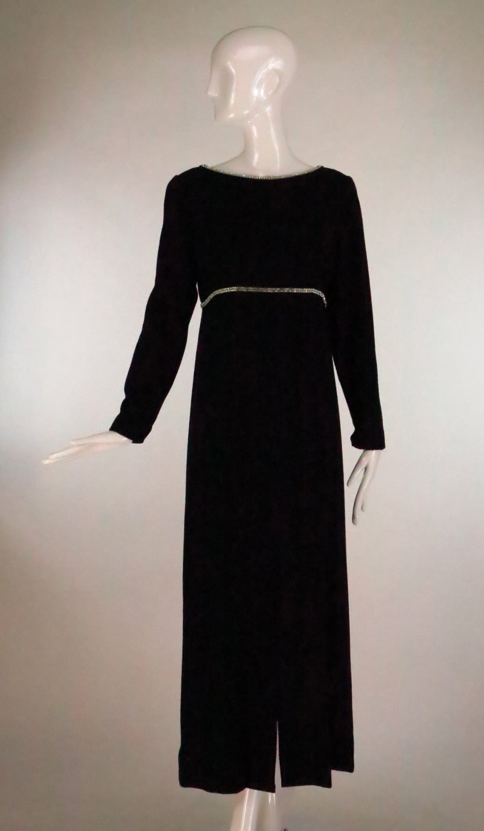 Mollie Parnis 1960s empire waist mod style maxi dress in black wool crepe...Open round neckline which dips low in the back is trimmed in a double row or rhinestones, there are also a double row of rhinestones under the bust...Long tapered