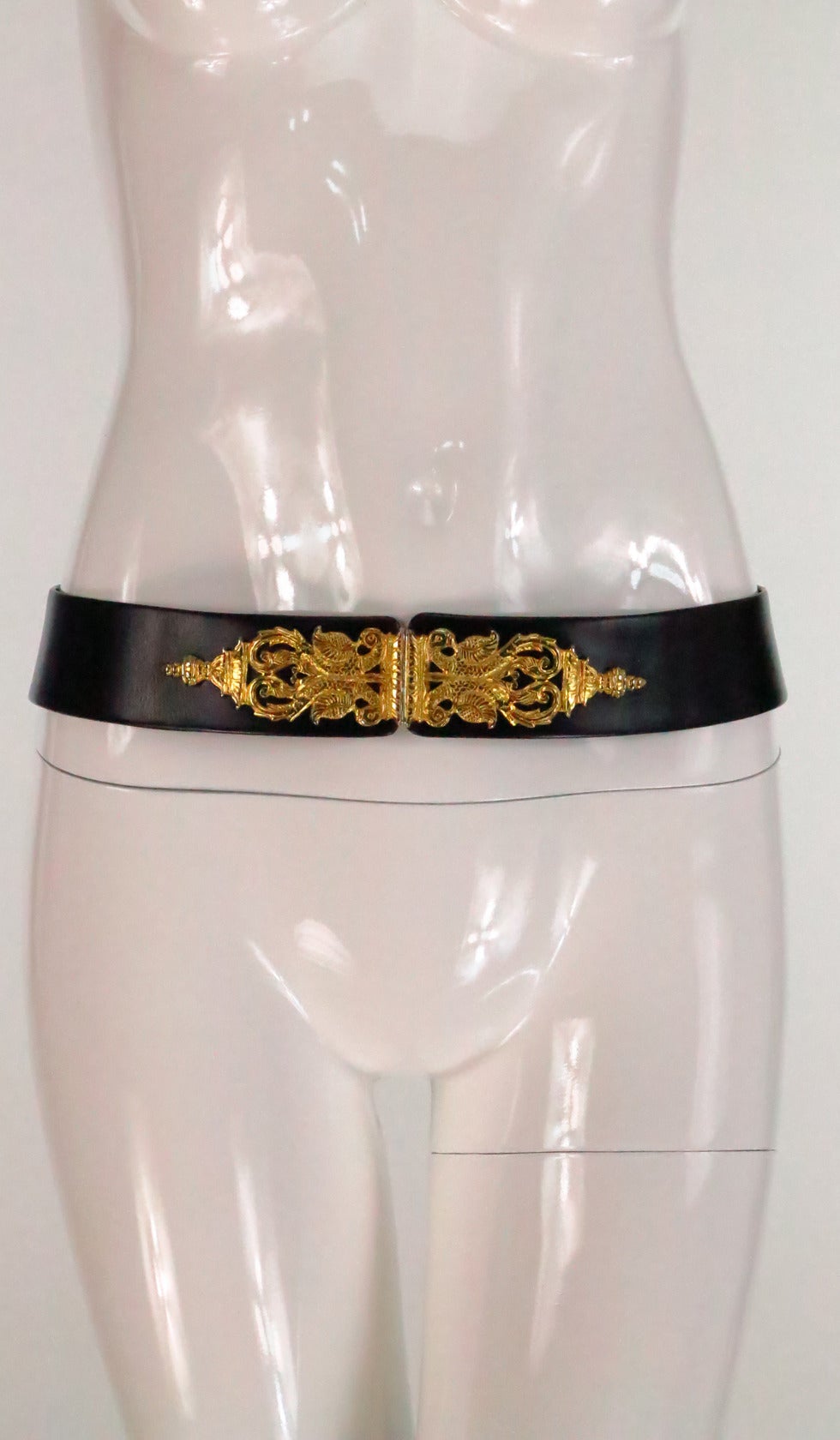 Judith Leiber black leather belt with gold clasps in the shape of Asian style pagodas..Fits a medium, the belt is adjustable...In excellent vintage condition...

Measurements are:
32” long
1 7/8” wide