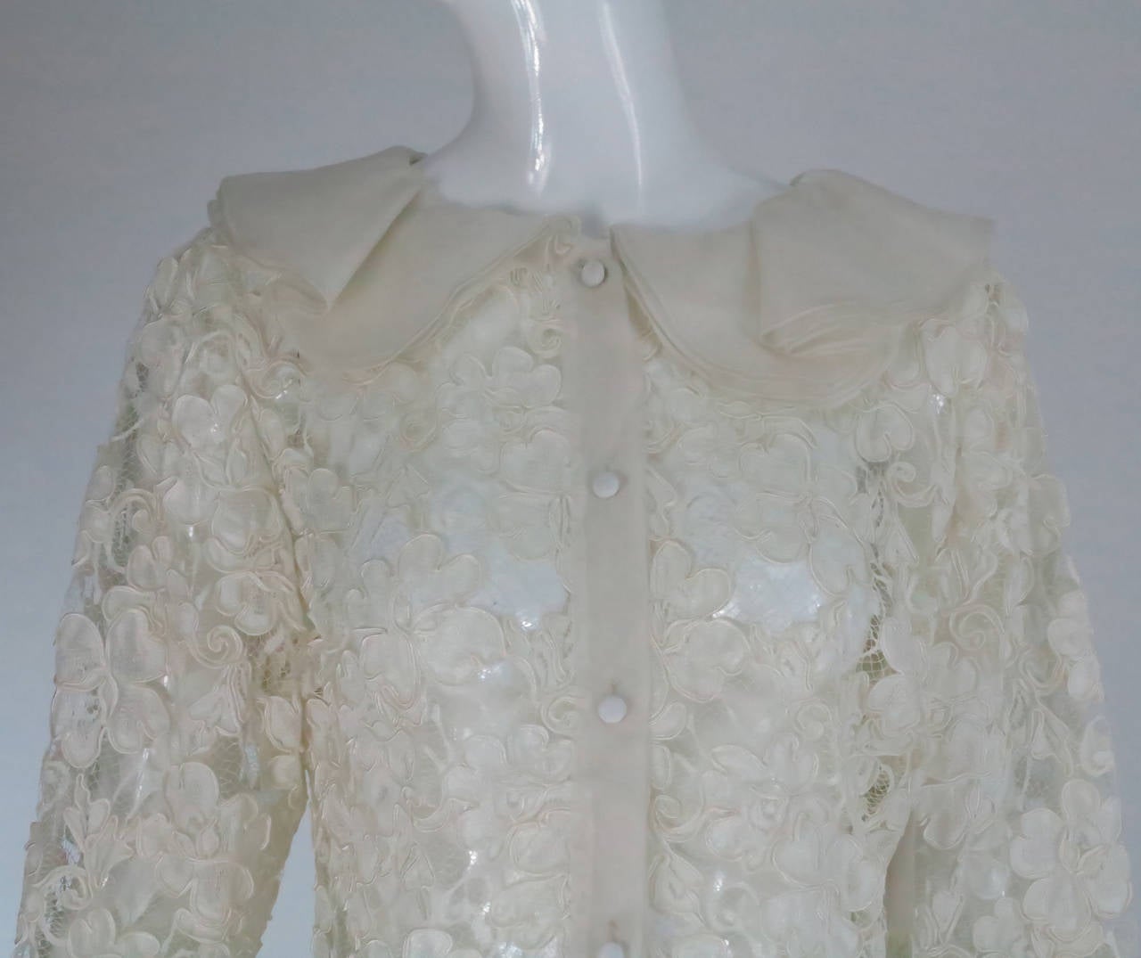 Carlos Arturo Zapata was a Colombian (SA) designer...From the 1970s...White with cream embroidery blouse is trimmed in cream silk organza ruffles...Slightly fitted style with lace edged hem...Unlined closes at the front with an organza placket and