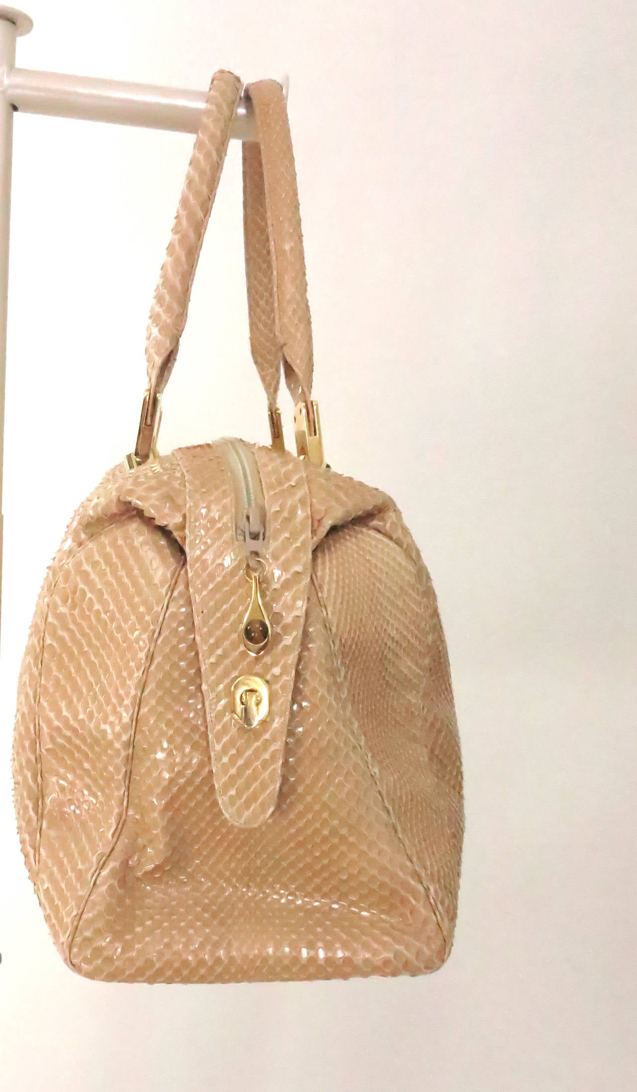 Gorgeous blond snake skin double handle tote bag by Judith Leiber...Large size tote had a top zipper entry that latches closed at each end for a sleek look...Gold hardware, zipper pull is set with a tiger's eye stone, gold feet at the bottom...Lined
