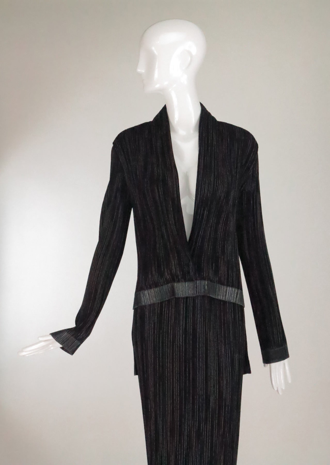 Black, white and silver pleated fabric with metallic thread...2pc Skirt and jacket set...The long sleeve jacket is unlined, with a shawl collar and tails at the back...The jacket closes with a single button at the front and there is a matching