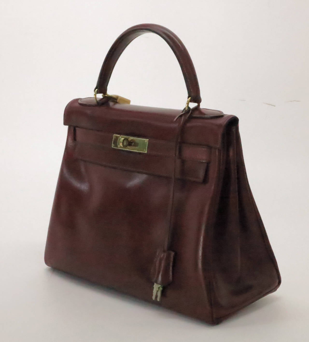 Hermes Kelly handbag...Beautiful rich burgundy box calf Kelly handbag dated P-1960…With lock, keys and cloche + protector bag…Wonderful 28cm size...In excellent well cared for condition…Original one owner, this bag did not come with a shoulder