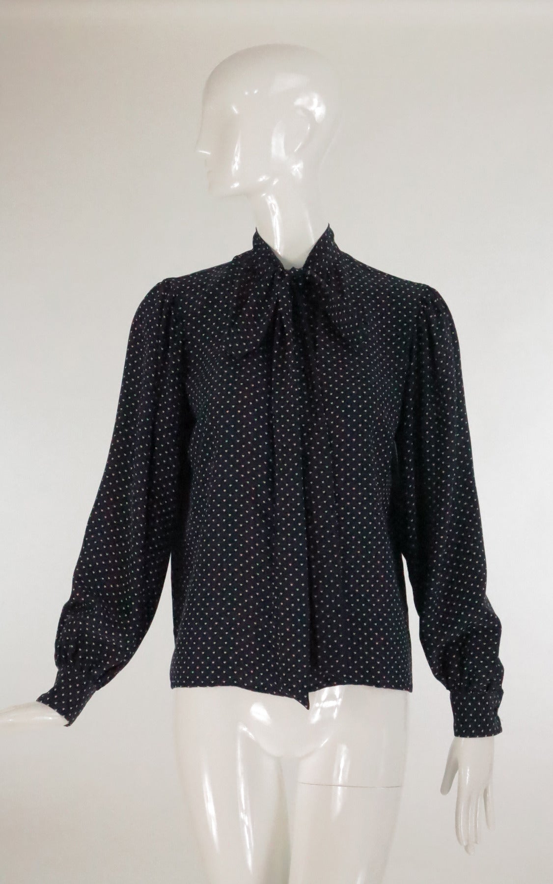 Yves St Laurent dark navy blue and white silk  tiny heart print blouse…Long sleeve button cuff blouse, closes with buttons at the front under placket and a bow tie at the neckline…Unlined…Marked size 38…Fits 4-6…

Please check the measurements