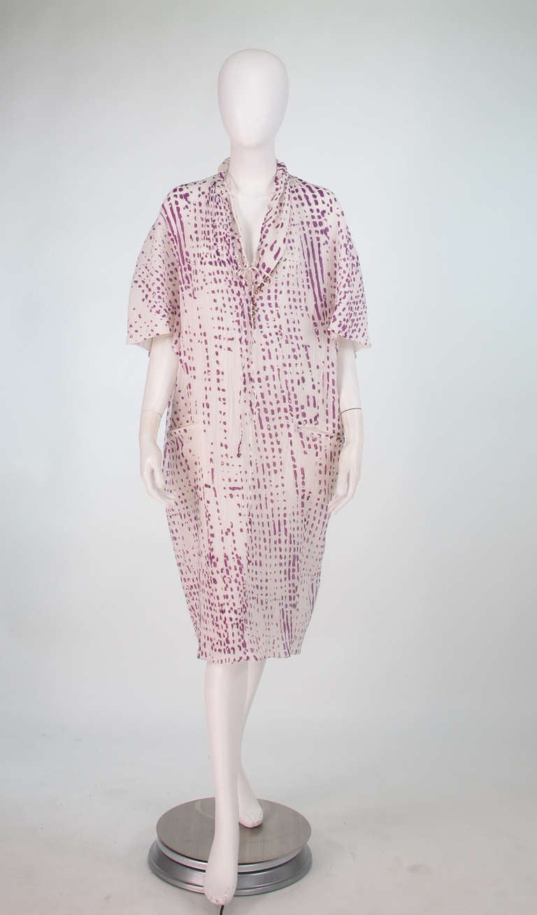 Yves St Laurent silk gauze sack dress...The perfect warm weather dress...Abstract print in lavender and white...Loop & button front  with interior drawstring and tie at the lower neckline...Wide sleeves...Hip front besom pockets...Dress is fully