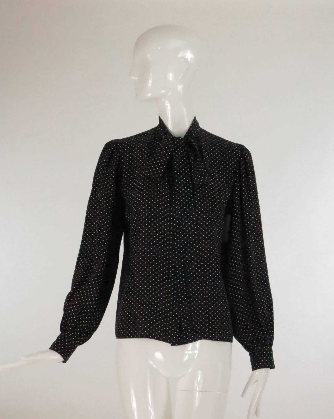 Yves St Laurent black and white silk tiny heart print blouse…Long sleeve button cuff blouse, closes with buttons at the front under placket and a bow tie at the neckline…Unlined…Marked size 36…Fits 4-6…

Please check the measurements provided