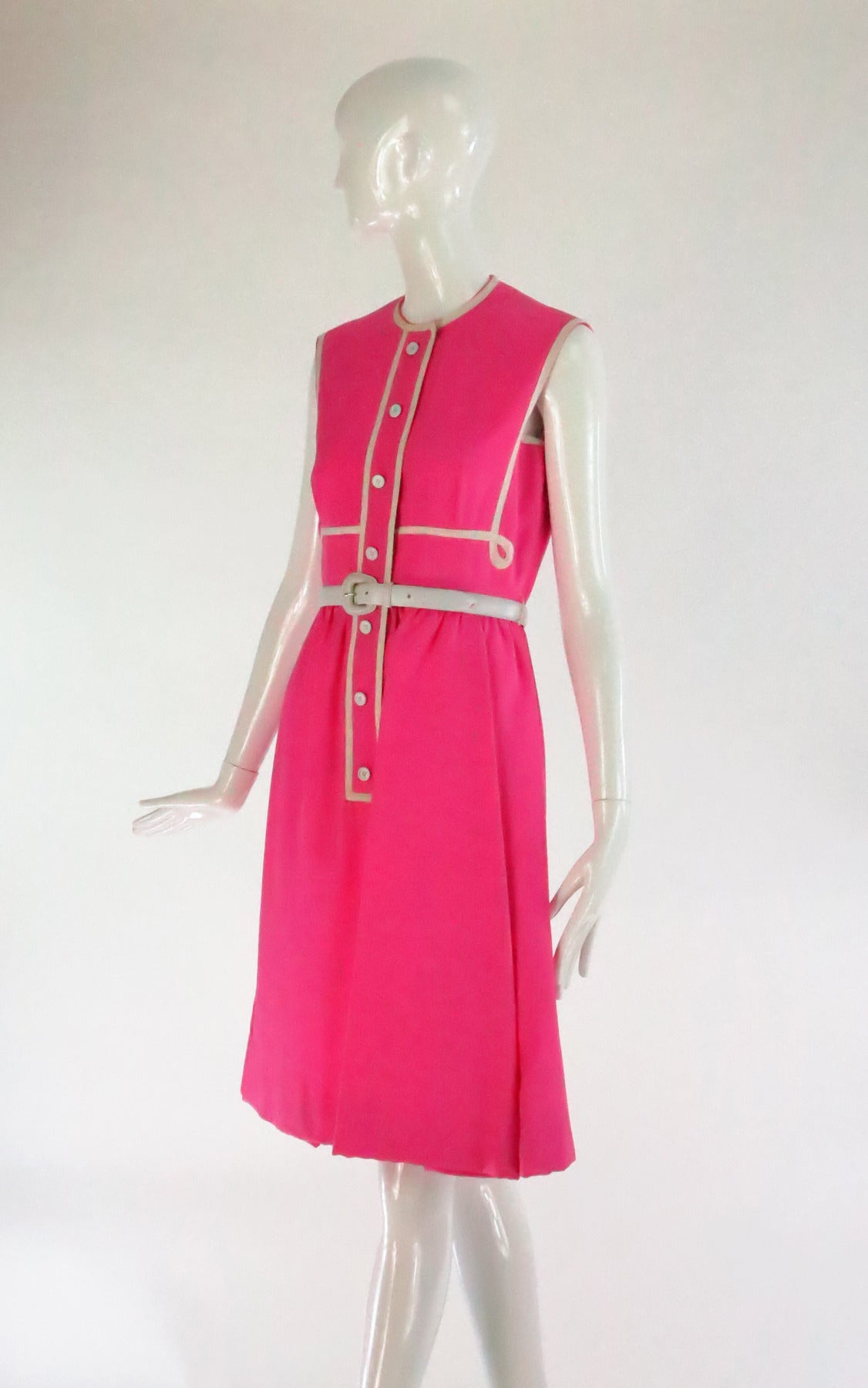 Geoffrey Beene pink & white linen sleeveless dress...The dress has white cord detail at the bodice, there is a placket with decorative buttons that conceals the hidden zipper...The skirt is softly gathered at the waist...Fully lined in pink