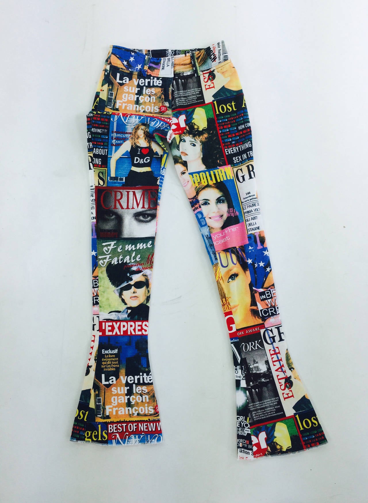 Dolce & Gabbana magazine photo trousers...lots of titles & photos...Stretch denim fabric...Look unworn...Low, with wide hip band, belt loops, front, below the waist band, banded pockets...Back hip flap button pockets...Tight with a small flair