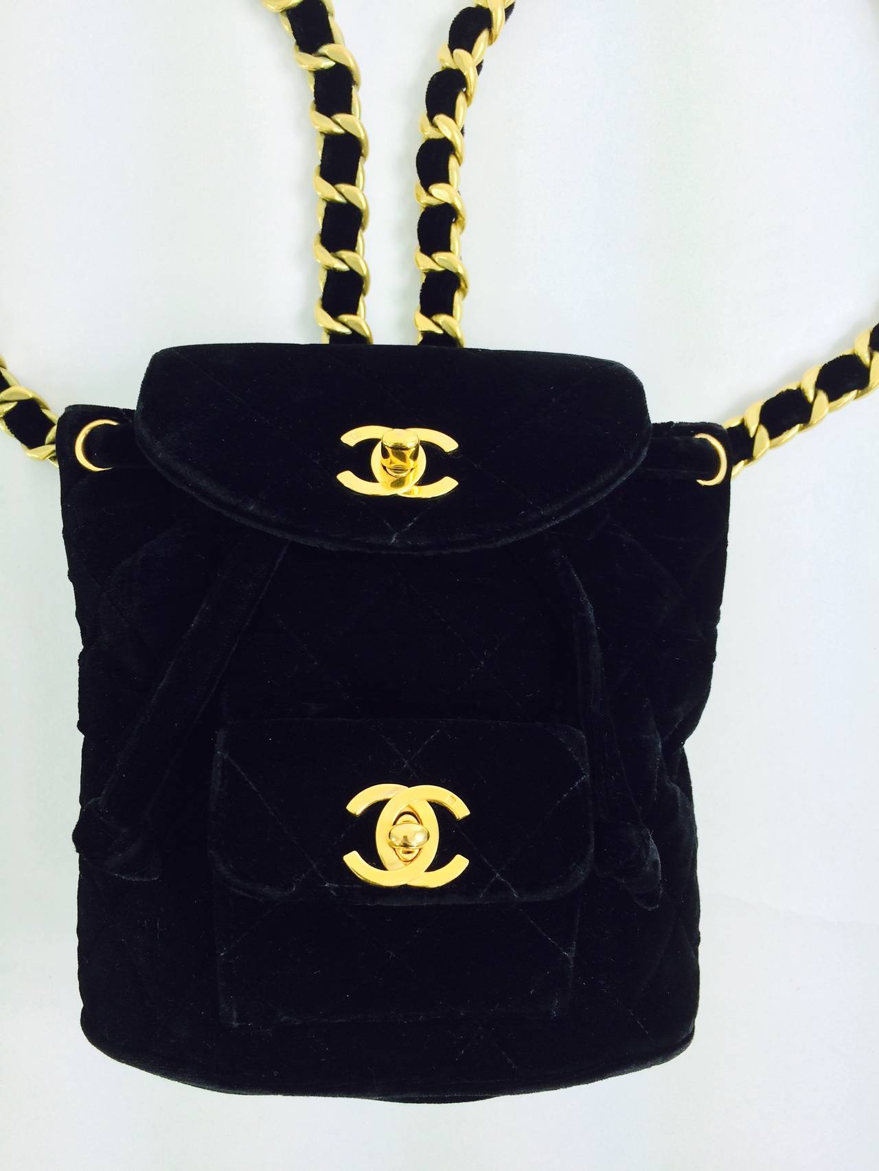 Chanel quilted black velvet, leather lined mini back pack 1996...Double shoulder straps have gold chain and adjustable buckles...Double flap fronts, the upper flap opens to the main compartment which is lined in black leather...The lower outside