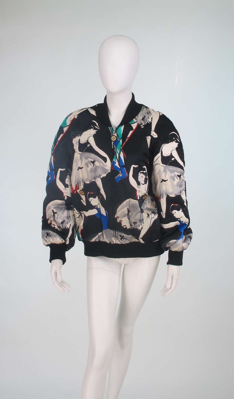 Chanel ballet print silk bomber jacket from the 1980s...Zipper front raglan sleeve jacket with logo pull, has a wonderful print design of ballerinas set against a black back ground...Knitted collar & cuffs...Two angled banded pockets at front sides
