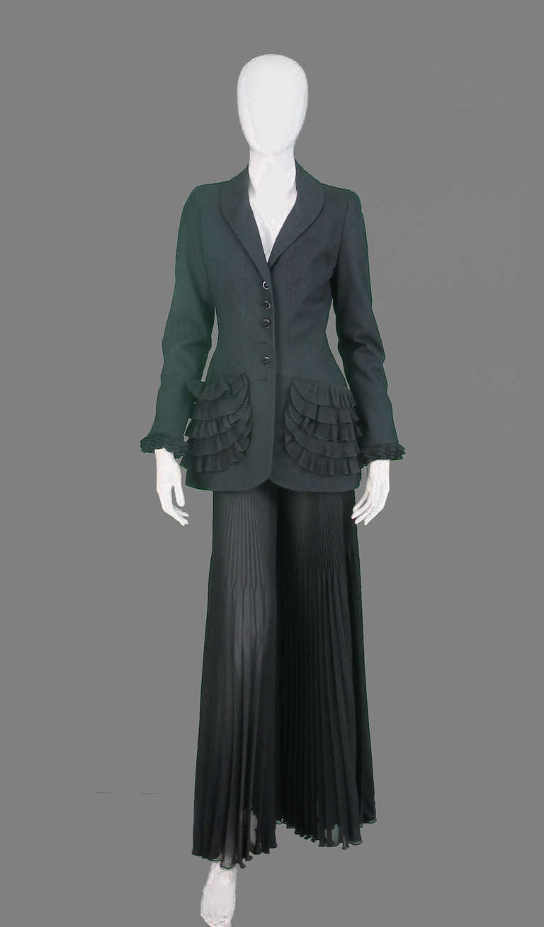 Chloe textured woven black cotton Jacket with coordinating  chiffon pleated palazzo pants...The fitted jacket has tiered ruffle pockets and ruffle cuffs...The pant sits at the natural waist and is fitted through the thigh (giving the illusion of