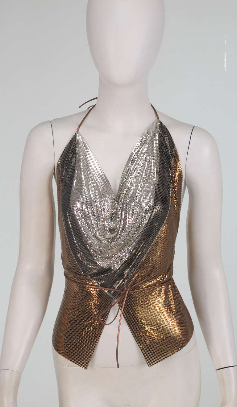 Shimmery metal mesh in gold, bronze and silver...1970s Whiting & Davis triple metal mesh halter top...Deep plunge neckline,with a chevron design...halter ties at the neck back with bronze leather ties...The back is totally open with ties at the