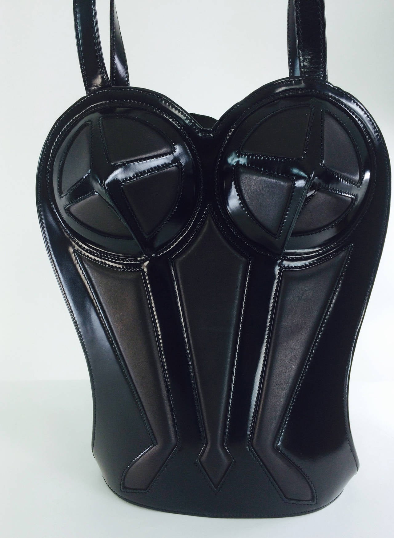 Jean Paul Gaultier 1998 structured black glazed leather and matte leather shoulder bag...Rare to find...Lined in black watered taffeta, there is a single zipper compartment...The bag zipps from the center down to the base of the bag allowing