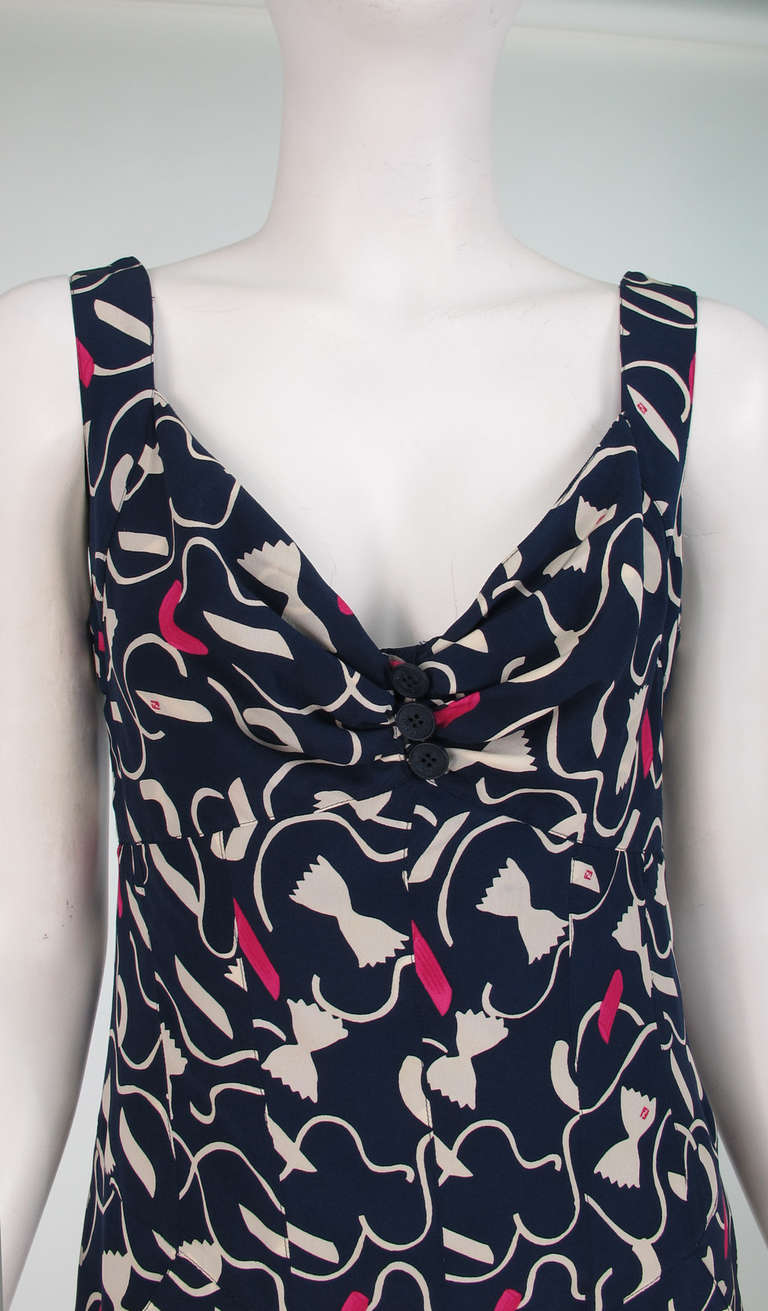 Form fitting silky rayon dress with a Tongue in cheek print of pasta in all shapes and sizes, navy blue ground, with white and hot pink pasta...Low V neckline with 3 button detail at the bust center front...Deep V at the back...Dress is fitted