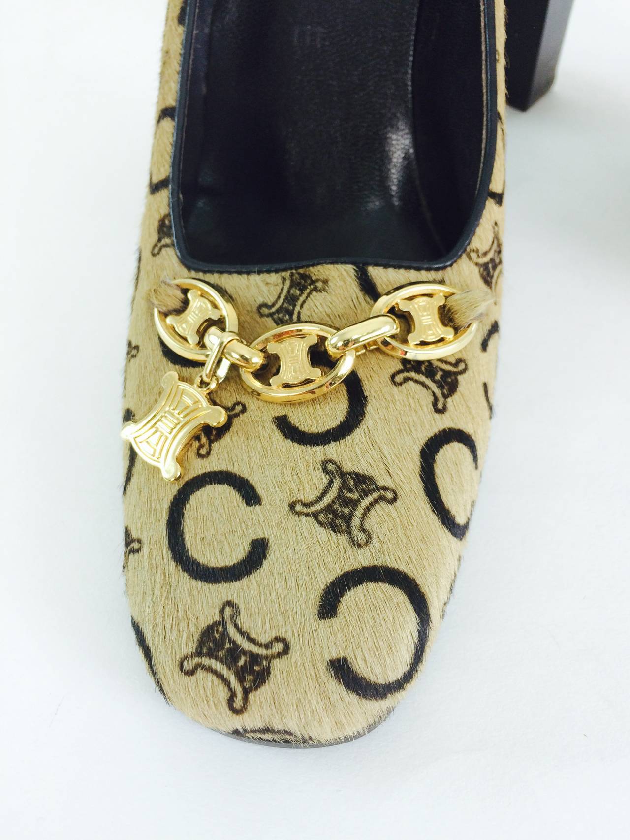 Gorgeous Celine logo stenciled pony hair heeled pumps with gold logo chain at the front...Marked size 37...Never worn....