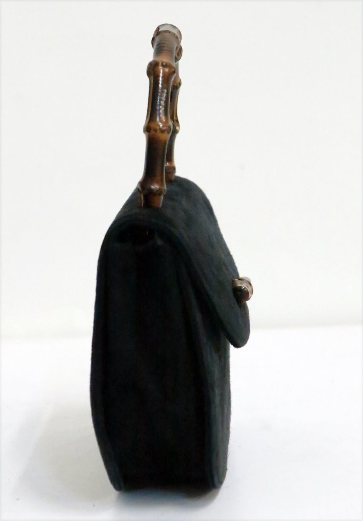 Classic Gucci bamboo handle handbag in a mini size, perfect for evening...Black suede with bamboo applique closure at the front and bamboo handle...Lined in black satin...In excellent condition

Measurements are:
7