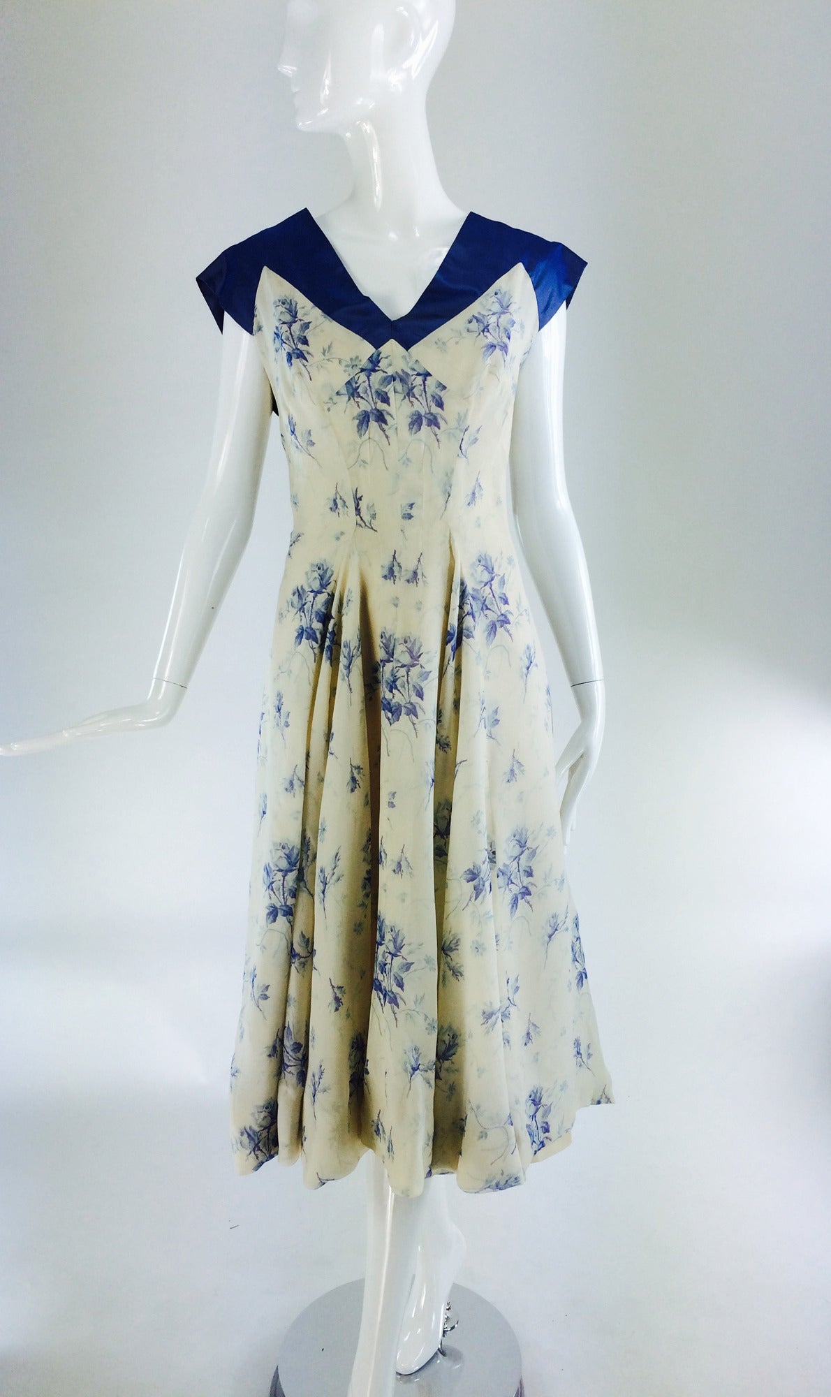 Carven, Paris Haute Couture, from the late 1940s or early 1950s...A dreamy silk chiffon and fine shot silk taffeta afternoon dress...Beautifully hand made...The shoulder, cap sleeves, upper bodice front and back with cross over tabs at the back are