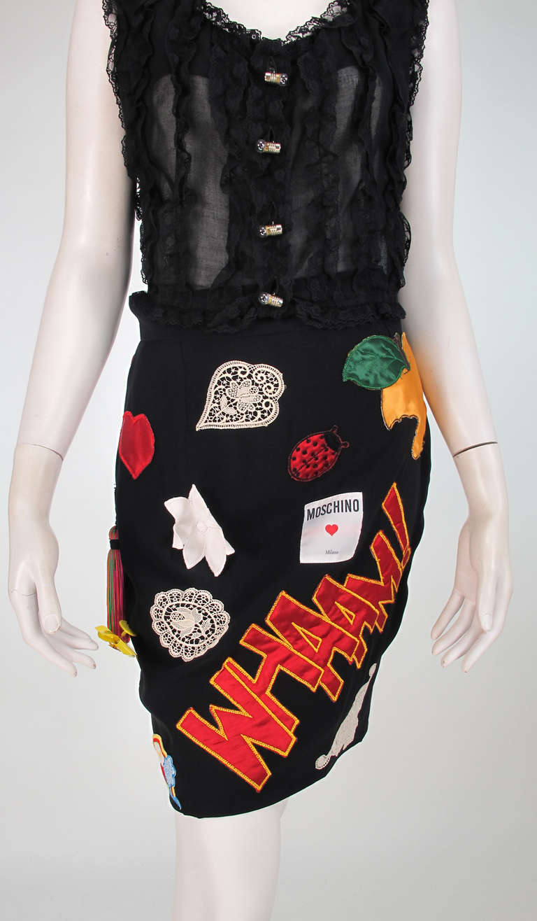 Rare 1980s Moschino applique 3 piece set, the lining is titled, The Best Things in Life are Free...Unique to find an original 3pc. set, Jacket, blouse and skirt...Long sleeve black jacket has assorted brass clothes pins, Moschino coins, light bulb