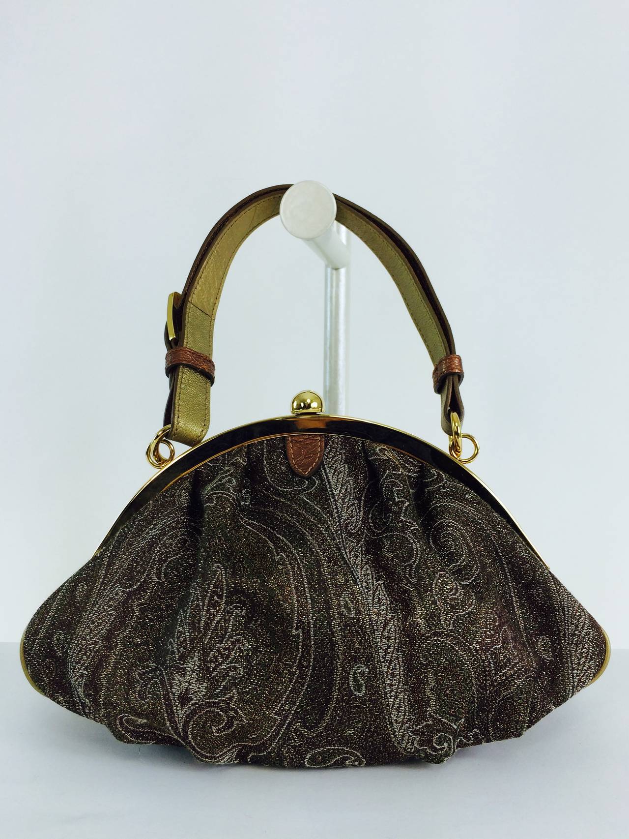 Etro metallic paisley fabric handbag with gold top frame and gold leather handle...Perfect for evening or day...The interior is lined in gold satin, there is a single open pocket inside...In excellent barely used condition...With protector bag and