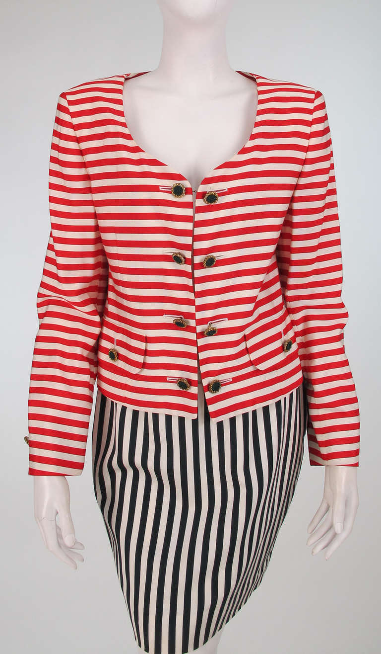 1980s Moschino red/black/white stripe skirt set...Low round neck jacket with horizontal red and white stripes, long sleeves, hip front flap pockets with button detail, closes at the front with gold buttons that have fabric centers, buttons on chains