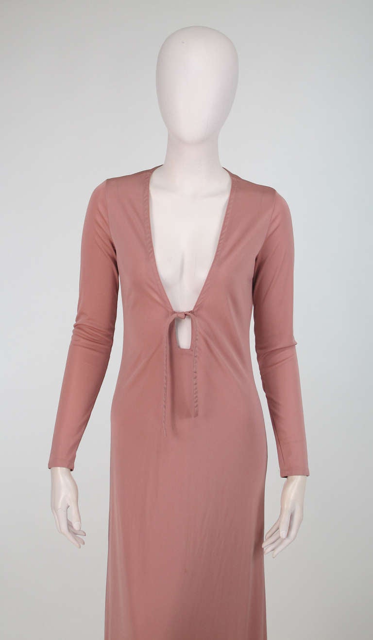 1970s John Kloss nude plunge front at home gown...Simple, clean & seductive define John Kloss's designs in the late 60s and 70s, using fluid fabrics that skimmed the body and required no darts or under pinnings...Nude, silky nylon jersey plunge